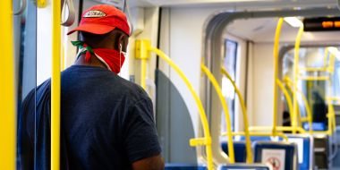 Man with face mask inside a train alone