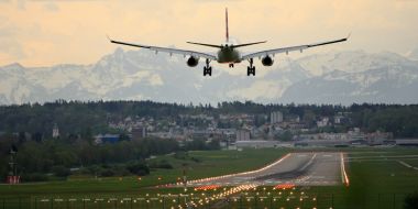 White biplane landing at airport